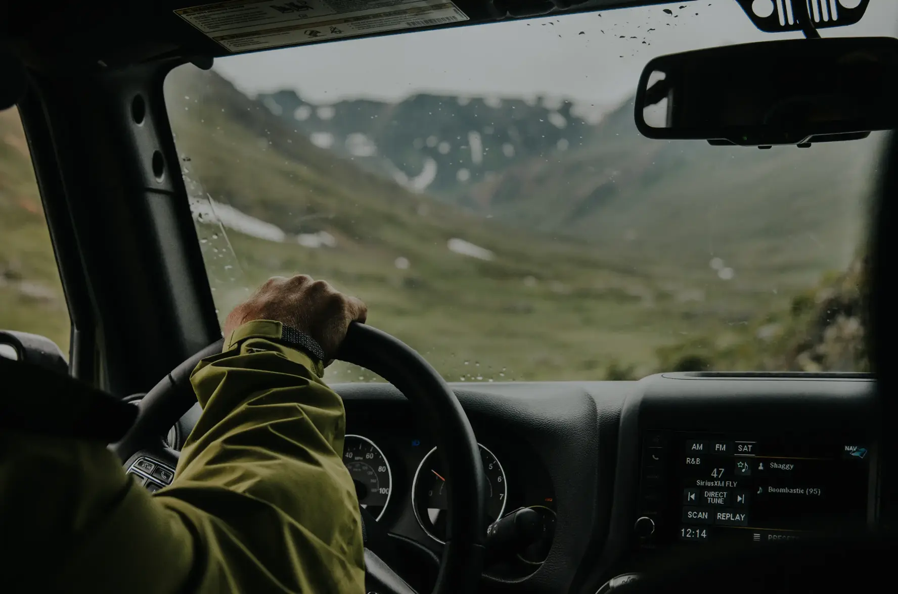 A behind shot of a man driving a car